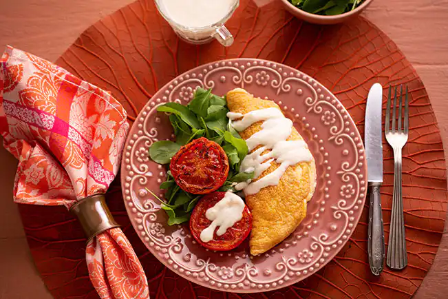 Omelete suflê com molho de queijo e tomate grelhado